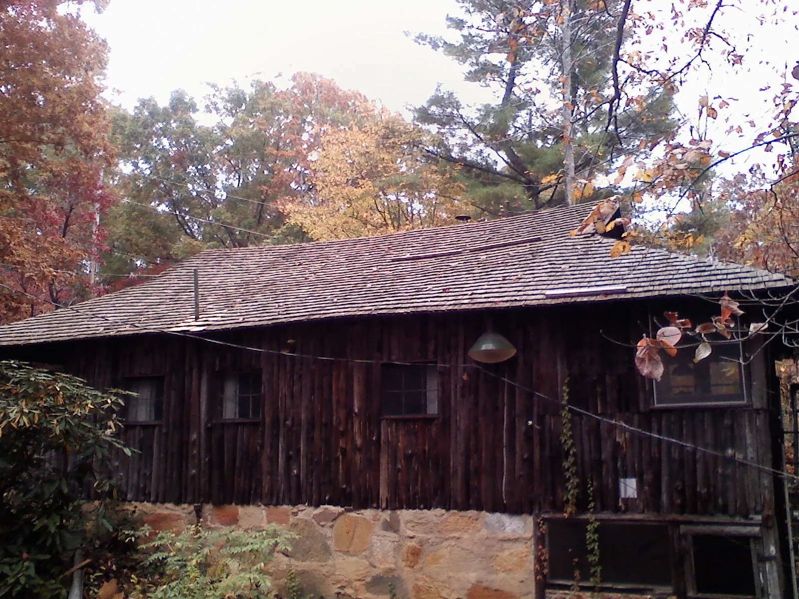 Weathered wood shake roof on a rustic board sided cabin in Gardner